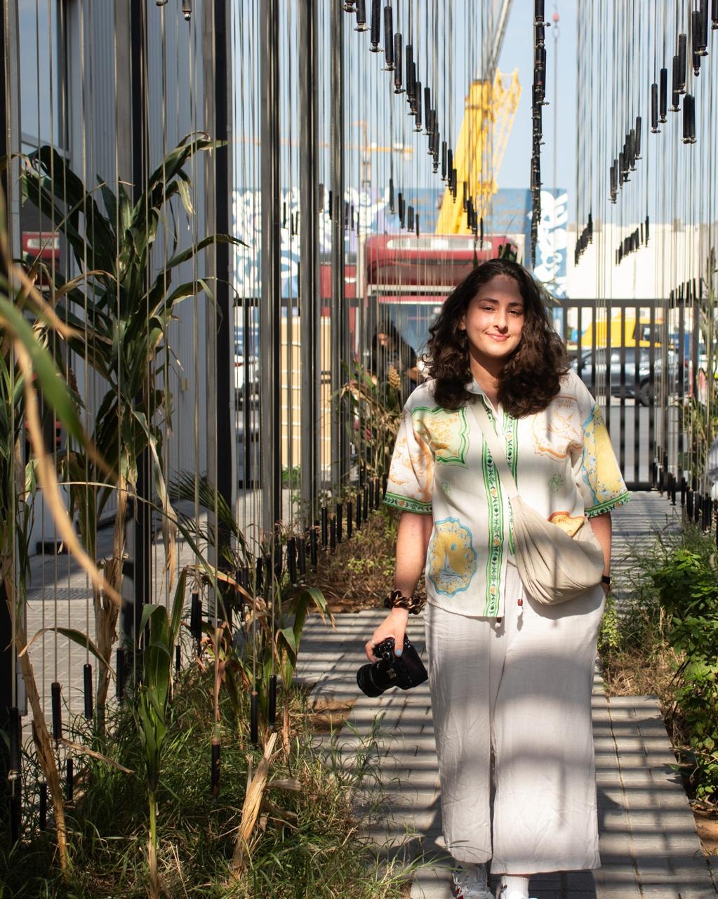 Sarah Mendonca, founder of Mendonca Visuals, holding her camera